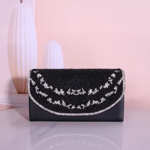 Black beaded evening clutch bag with sparkling rhinestone curves, elegant accessory detail shot.