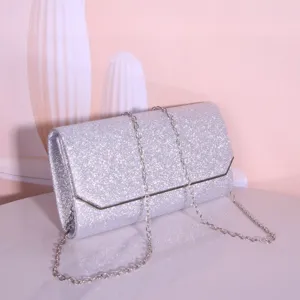 Silver glitter evening clutch bag with metallic chain strap for women's party wear.