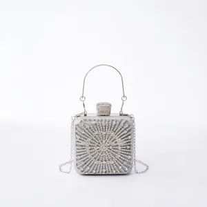 Silver rhinestone evening clutch bag with metal handle and chain for party and wedding events.