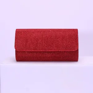Red glitter evening clutch bag detail view, sparkling party purse with flap and magnetic snap closure.