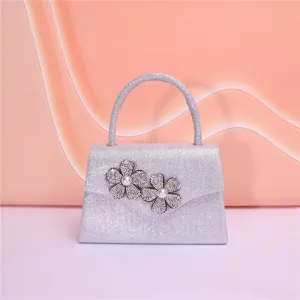 Elegant silver evening bag with sparkling rhinestone flower and pearl details for party use.