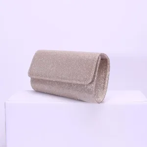 Detailed view of the champagne glitter evening clutch bag, elegant magnetic snap flap design.