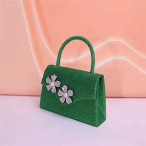 Elegant green glitter evening bag with sparkling rhinestone flowers and delicate faux pearls.