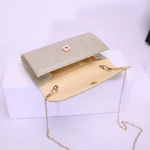 Elegant gold glitter clutch bag with chain strap for evening party and wedding events.