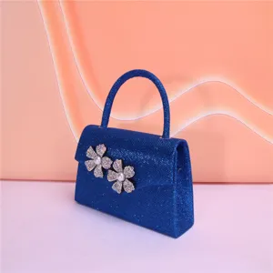 Elegant blue glitter evening bag featuring stunning rhinestone and pearl flower decor.