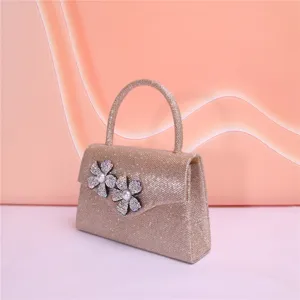 Sparkling glitter evening handbag detail, elegant rhinestone flower and pearl decor, chic style.