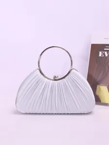 Detail view of silver pleated evening clutch bag with elegant metal ring handle.