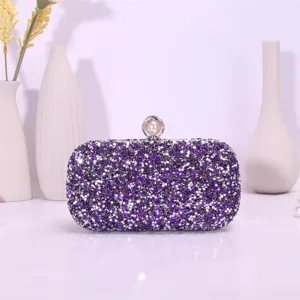 Detailed view of the sparkling purple rhinestone evening clutch bag with elegant pearl clasp.