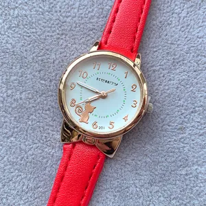 Red leather strap women quartz watch with cute cat dial and gold case detail view.