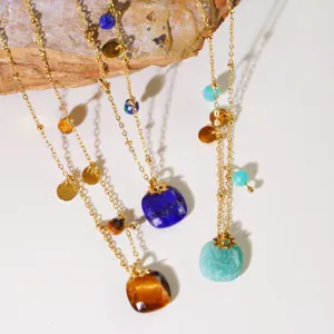 Detailed close-up of natural stone pendant necklaces featuring delicate gold chains and colorful gems.