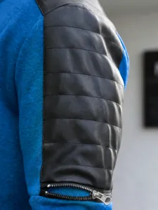 Detailed shot of men's casual jacket sleeve with contrast color block and zipper cuff.