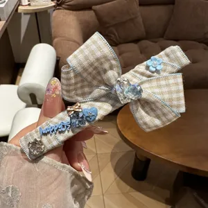 Korean style plaid bow hair clip with cute rhinestone and blue happy letter design.