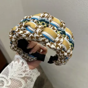 Chic houndstooth woven wide headband with multi-color ribbon and gold chain detail.
