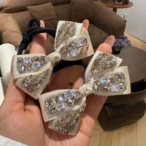 Champagne rhinestone bow hair tie detail, elegant crystal satin scrunchie for women.