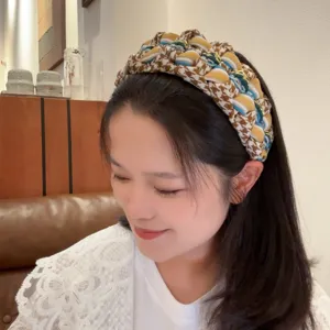 Detail shot of the retro houndstooth braided headband, showing exquisite multi-color texture.