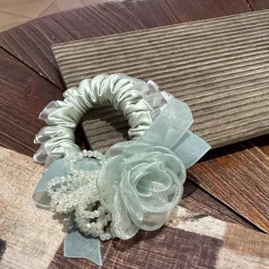 Elegant light green floral scrunchie with crystal bead fringe, sweet lace edge hair accessory.