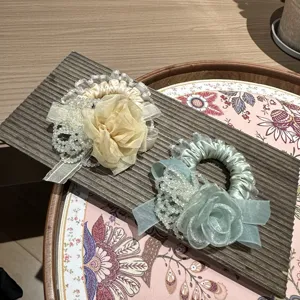 Close-up detail of korean style sweet flower hair scrunchie with lace and pearls.