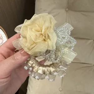 Chic floral scrunchie detail featuring a delicate chiffon flower lace trim and crystal beads.