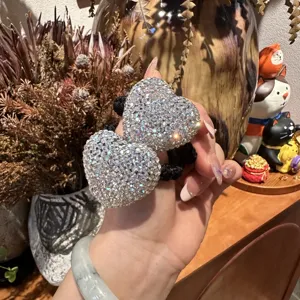 Sparkling rhinestone double heart hair tie detail, elegant black elastic ponytail holder.