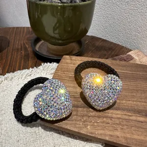Sparkling rhinestone heart hair tie, elegant crystal hair band for chic ponytails and buns.
