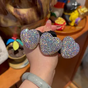 Sparkling crystal heart hair tie detail, elegant rhinestone pony tail holder fashion accessory.