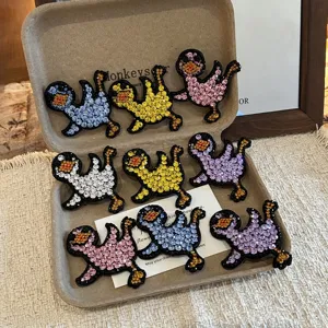Cute rhinestone duck hair clips, sparkling crystal side snap clips, fun fashion accessories.