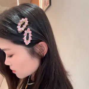 Close-up detail of stylish pink crystal hair clips, elegant side hair clip for women daily wear.