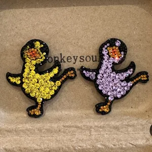 Detailed closeup of cute cartoon duck hair clips, sparkling rhinestones, vivid styling.