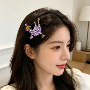 Closeup detail of a cute rhinestone duck hair clip worn on side bangs for a sparkling look.