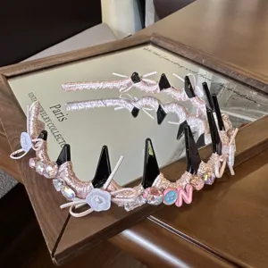 Pink spiked studded headband with crystals, rhinestones, ribbons and charms for women.