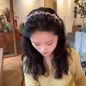 Pink pearl bow headband detail shot showing cute hair accessories for daily wear and styling.