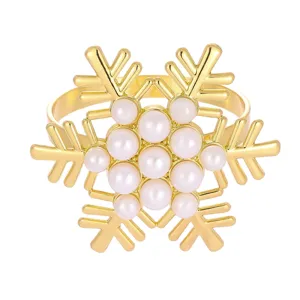 Rond de serviette de noel en forme de flocon dore avec perles pour deco de table.