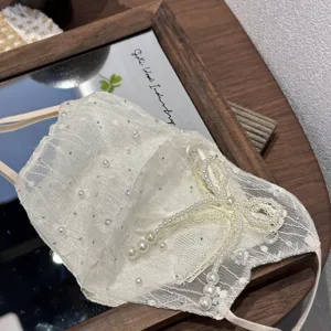 Elegant white lace face mask featuring sparkling rhinestones and pearl bow details for women.