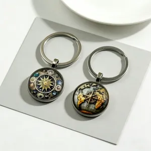 Metal alloy keychain featuring universe planet constellation and compass glass dome design.