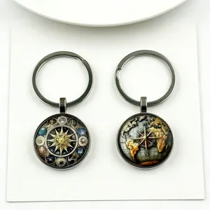 Celestial compass keychain set featuring cosmic zodiac and world map glass cabochons.