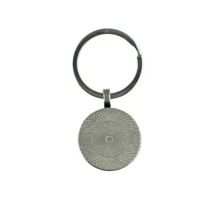 Metal keychain detail showing the intricate circular geometric pattern pendant and ring.