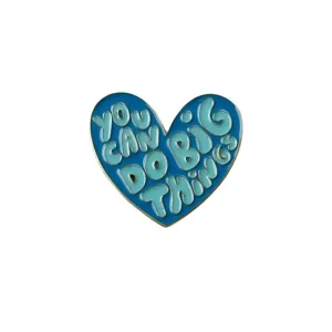 Detailed shot of the blue heart enamel pin featuring inspiring English quotes for daily wear.
