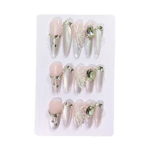Handmade press-on nails with extra long pointy shape, cat-eye effect and rhinestone decor.