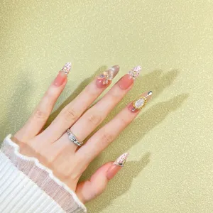 Close-up of luxury press-on nails featuring tweed pattern, rhinestones and cat-eye effect.