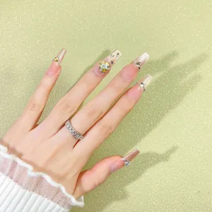Handcrafted nude gradient press-on nails featuring sparkling rhinestones and chic design.