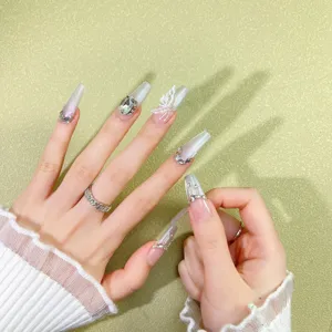 Handcrafted press-on nails featuring cat-eye effect, rhinestones and 3D butterfly details.