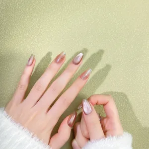 Handcrafted champagne gold cat-eye press-on nails detail view showcasing delicate fine glitter.