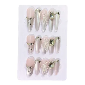 Handmade press-on nails with cat eye effect, 3D butterfly and crystal rhinestones for elegant style.