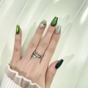 Handmade green cat eye press-on nails detail, exquisite rhinestone and gradient style.