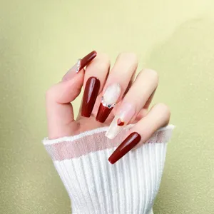Burgundy press-on nails, long coffin shape with glitter, rhinestones, and cute heart design.