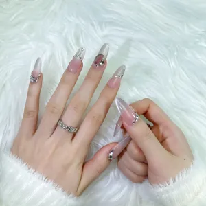 Uñas postizas hechas a mano degradado nude con cadena plateada y brillantes pedrerías.