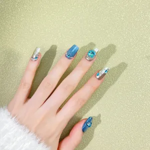 Handmade luxury cat eye press on nails with dazzling blue rhinestones and glitter finish.