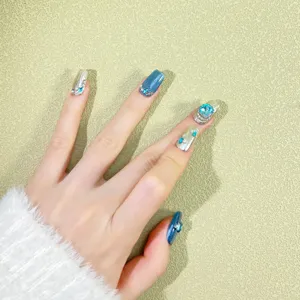 Handmade press-on nails with blue cat-eye, silver finish, and rhinestones for luxurious style.