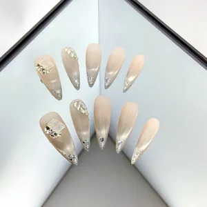 Handcrafted nude pink gradient press-on nails with cat eye effect and luxurious crystal rhinestones