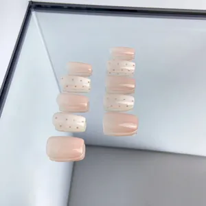 Short nude pink press-on nails with brown polka dots, glossy finish fake nails for daily wear.